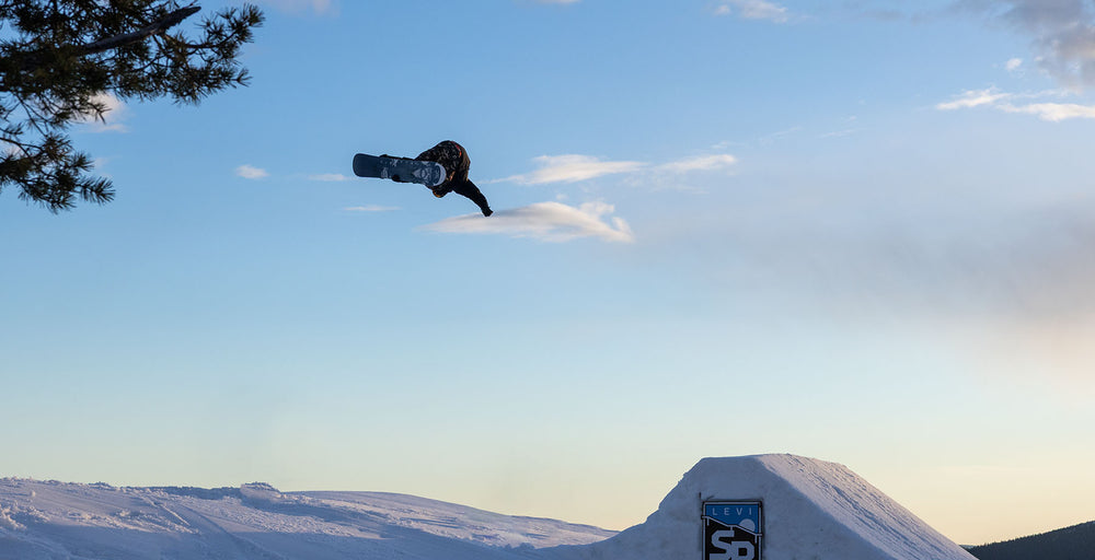 Snowboarder catching air off a terrain park jump